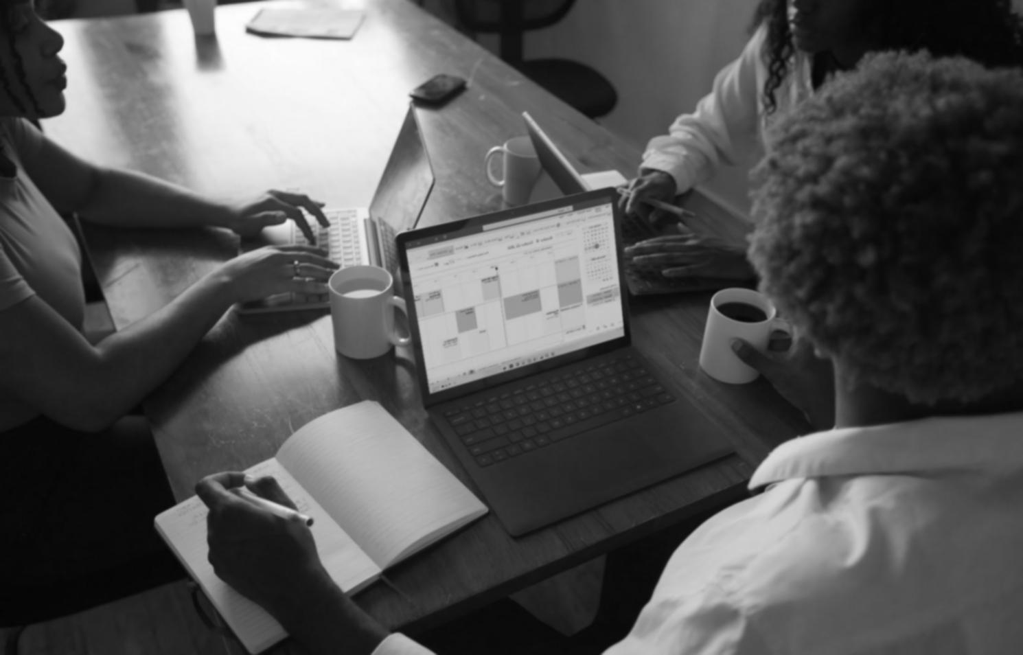 Financial analyst reviewing fraud detection patterns on computer screens showing transaction data and risk assessment dashboards